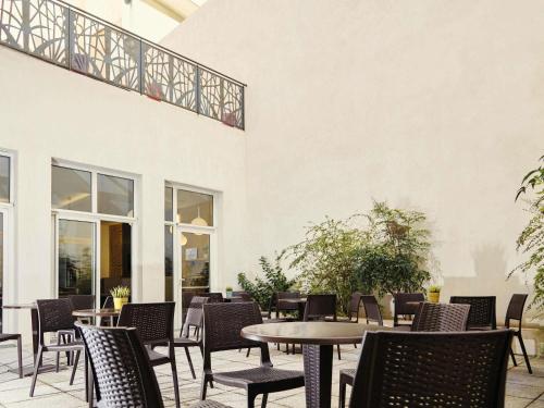 a patio with tables and chairs and a building at ibis Styles Marseille Gare Saint-Charles in Marseille