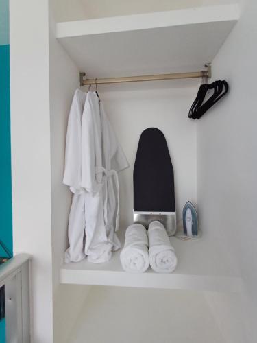 a shelf in a bathroom with towels on it at Casa Linda Isla Loft- Ocean View- Shared Pool in Isla Mujeres