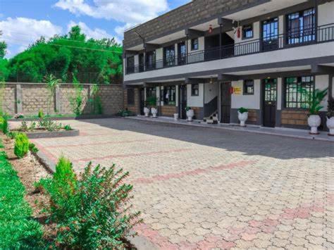 a large building with a brick driveway in front of it at R&R -Weber One bedroom Naivasha, Old Naivasha Moi South lake road in Naivasha