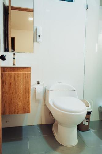 a bathroom with a white toilet in a room at 24seven Hotel Boutique in Duitama