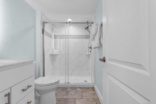 a white bathroom with a shower and a toilet at Sandy Horizon in Myrtle Beach