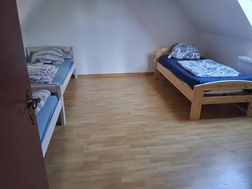 a room with two bunk beds and a wooden floor at Appartement le Sourire in Neumünster