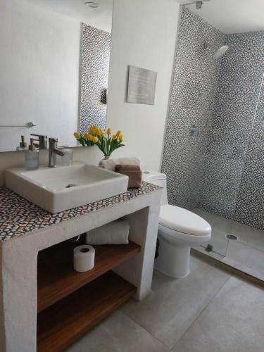 a white bathroom with a sink and a toilet at Casa Monarcas - Josefina (with AC) in Guadalajara