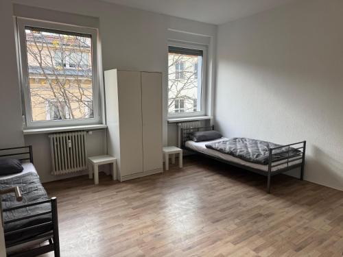 a room with a bed and two windows at Wohnquartier GbR in Worms
