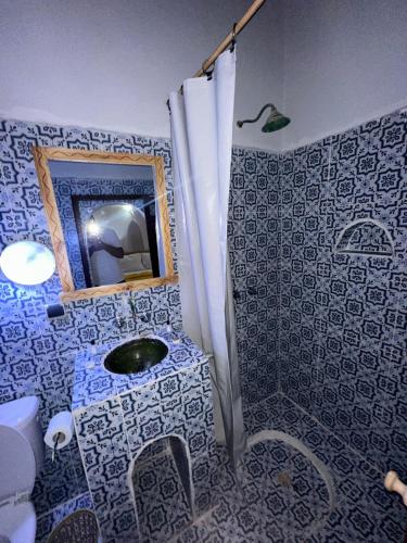 a bathroom with a sink and a mirror at Riad Dar Zaouia in Zagora