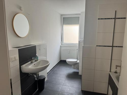 a white bathroom with a sink and a toilet at Wohnquartier GbR in Worms