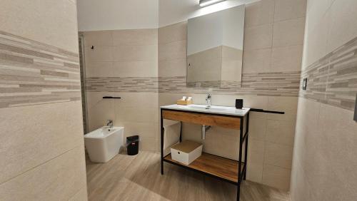 a bathroom with a sink and a toilet at Talenti Suites Rome Casa Vacanze in Rome