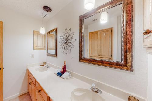 a bathroom with a sink and a mirror at Camp Warnecke Estates Unit B109 in New Braunfels