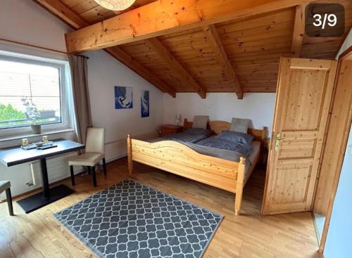 a bedroom with a bed and a desk and a window at Casa Boebelle in Bük