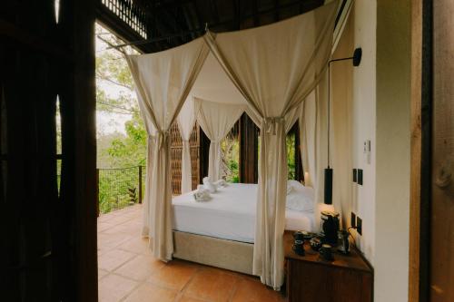 a bedroom with a bed with a canopy at Sandagua Hotel-Doradal, Antioquia in Puerto Triunfo