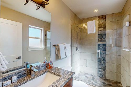 a bathroom with a shower and a sink and a tub at Rim View 7 in Spanish Valley