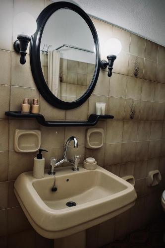 a bathroom with a sink and a mirror at ElaPhos HOUSE in Kiriákion