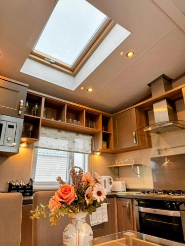 a kitchen with a vase with flowers on a counter at 2Bedroom Comfy & Cosy family loving Home in Chichester