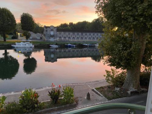 a view of a lake with boats in it at Les appartements de l'Orangerie in Jarnac