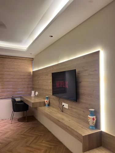 a lobby with a desk and a television on a wall at Elite Stay near Expo Mart Delta 1 metro in Greater Noida