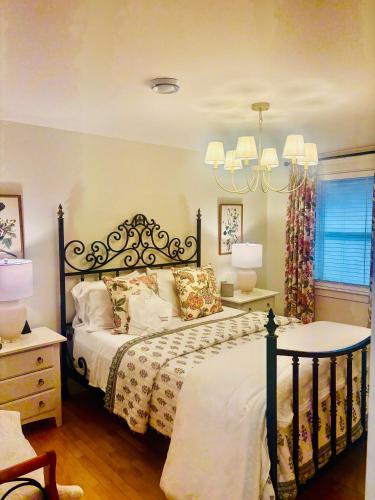 a bedroom with a bed and a chandelier at The Beaverpond Getaway Suite in Brigus