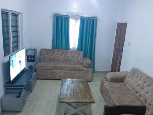 a living room with a couch and a tv at Changamwe accomodations in Mombasa