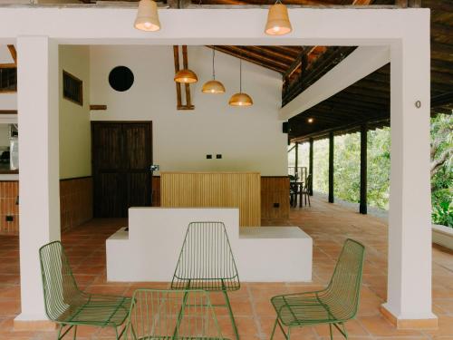 a living room with chairs and a table at Sandagua hotel in Puerto Triunfo