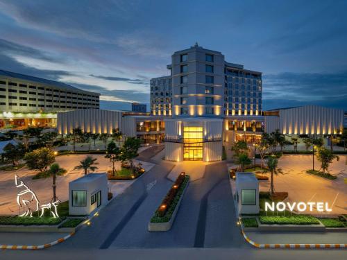 a view of a building in a city at night at Novotel Rayong Star Convention Centre in Rayong
