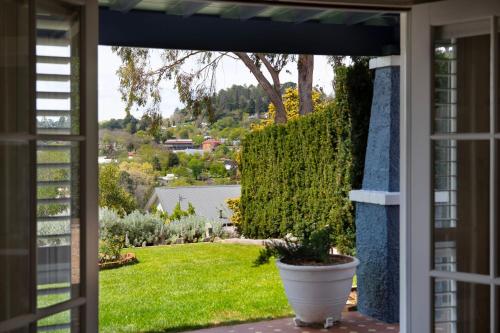 a door leading to a yard with a potted plant at Churchills - outstanding views over Daylesford in Daylesford