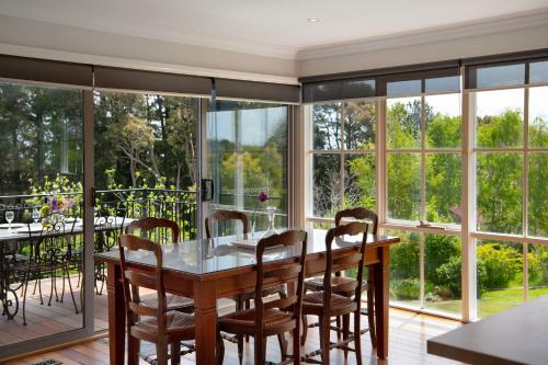 a dining room with a table and chairs at Churchills - outstanding views over Daylesford in Daylesford