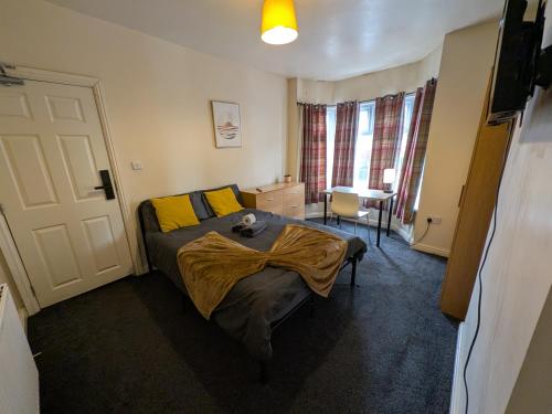 a bedroom with a bed with a blanket on it at Stay Sleep Rest - Firth Park in Wincobank