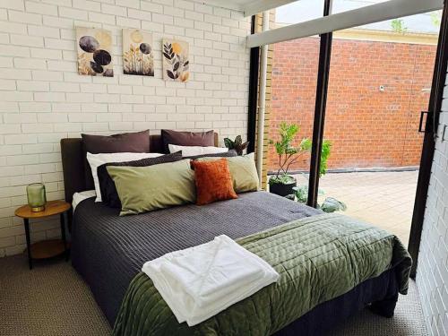 a bedroom with a large bed and a large window at Young unit1 Water Views in Nagambie