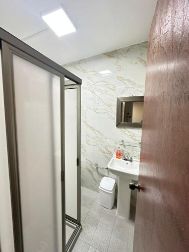 a bathroom with a toilet and a sink at Don Charlie in Veracruz