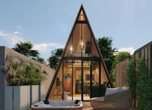 a house shaped like a triangle with a tub on a patio at Cabanas Farol in Pântano Grande