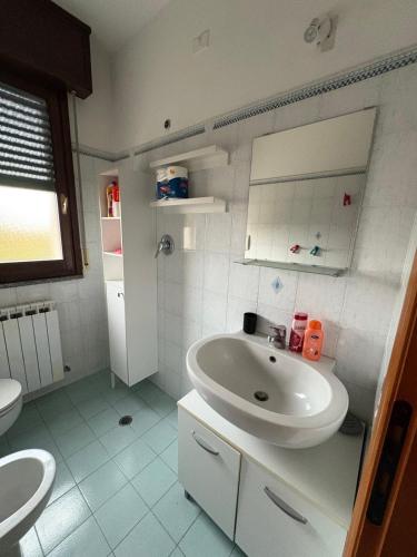 a white bathroom with a sink and a toilet at Bartoli 8, Viserbella di Rimini in Rimini