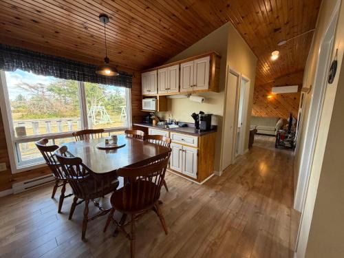 a kitchen and dining room with a table and chairs at Stanhope Cottages in Stanhope
