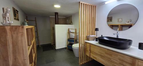 a bathroom with a black sink and a mirror at Cap Nord in Cap Malheureux