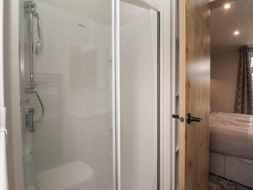 a shower with a glass door in a bathroom at Meadows Park 3 in Hull