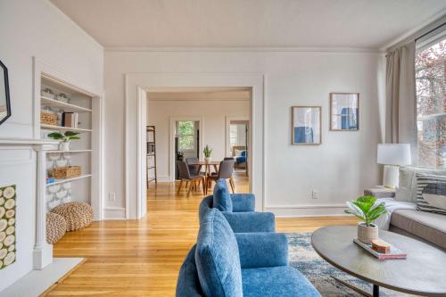 a living room with a blue couch and a table at Stay Portland - La Casa Burnside - Local Eateries, Shops, and Bars in Portland