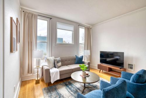 a living room with a couch and chairs and a tv at Stay Portland - La Casa Burnside - Local Eateries, Shops, and Bars in Portland