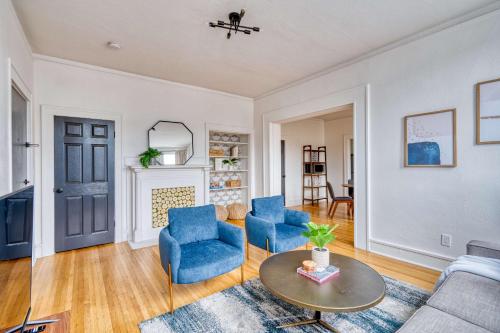 a living room with blue chairs and a table at Stay Portland - La Casa Burnside - Local Eateries, Shops, and Bars in Portland