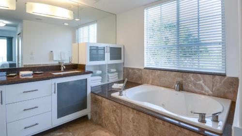 a bathroom with a large tub and a sink at 131 Mariners Club in Key Largo