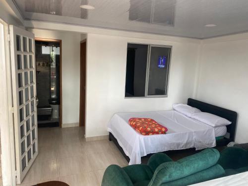 a bedroom with a bed and a couch in it at La bendición de sunnyvale in La Vega