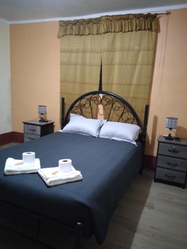 a bedroom with a bed with two towels on it at Casa Hospedaje in Ayacucho