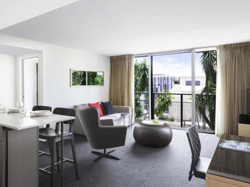 a living room with a couch and a table at Mantra South Bank Brisbane in Brisbane