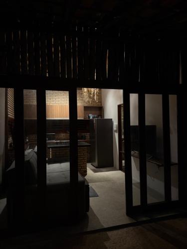a view of a living room with a tv in a room at Bangalô raizes in São Gonçalo do Amarante