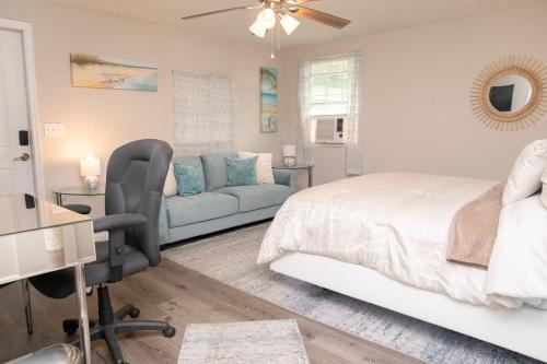 a bedroom with a bed and a desk and a couch at Serene Studio Retreat in Jacksonville
