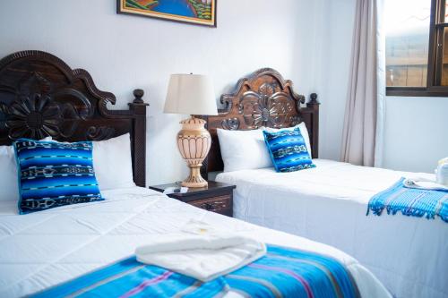 Postel nebo postele na pokoji v ubytování Hotel Taa' Tiin