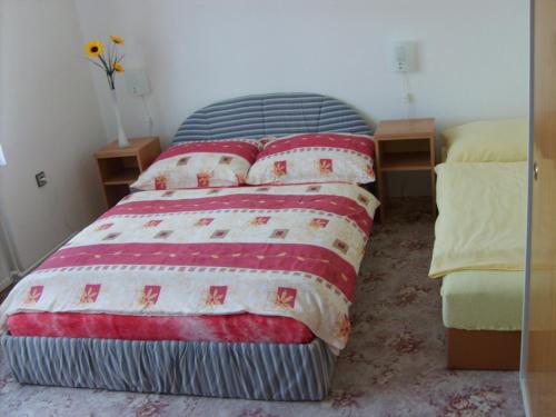 a bedroom with a bed with pillows on it at Apartmán Eva in Crhov