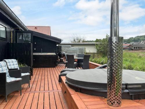 a patio with a table and chairs on a deck at 6 person holiday home in Sjølund-By Traum in Binderup Strand