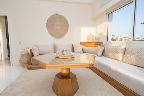 a living room with a couch and a table at Ocean Dream - Spacious Duplex with Ocean View, Astonishing Sunset - 4 Bedrooms with Balcony - WIFI, IPTV in Tangier