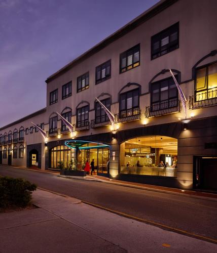 a building with lights on the side of a street at Great Southern Hotel Perth in Perth