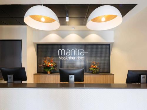 a waiting area of a martinez molecular hotel with two lights at Mantra MacArthur Hotel in Canberra