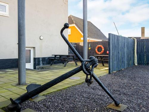 a large anchor in the yard of a house at 6 person holiday home in Thyborøn in Thyborøn