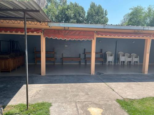un pavillon avec des chaises et des tables à l'intérieur dans l'établissement Casa de descanso Emiliano, à Salta